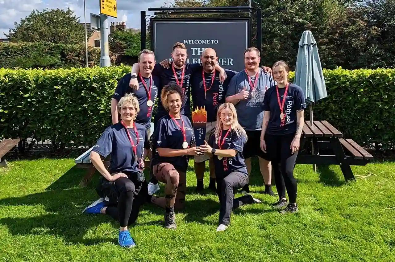 Group of charity walkers celebrating at the end of their relay