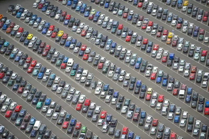 Large business car park with rows of parked cars