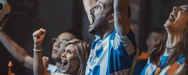 Sports fans cheering in a pub
