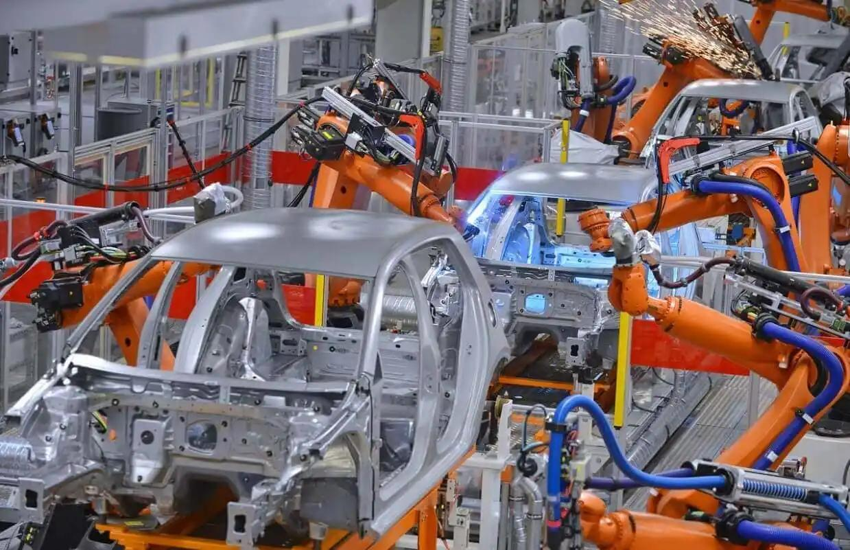 A robotic arm assembling car parts on a production line, showcasing automation in the automotive industry.