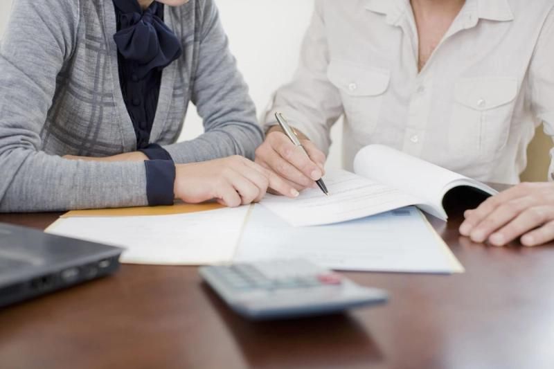 Business owners writing in their accounts book