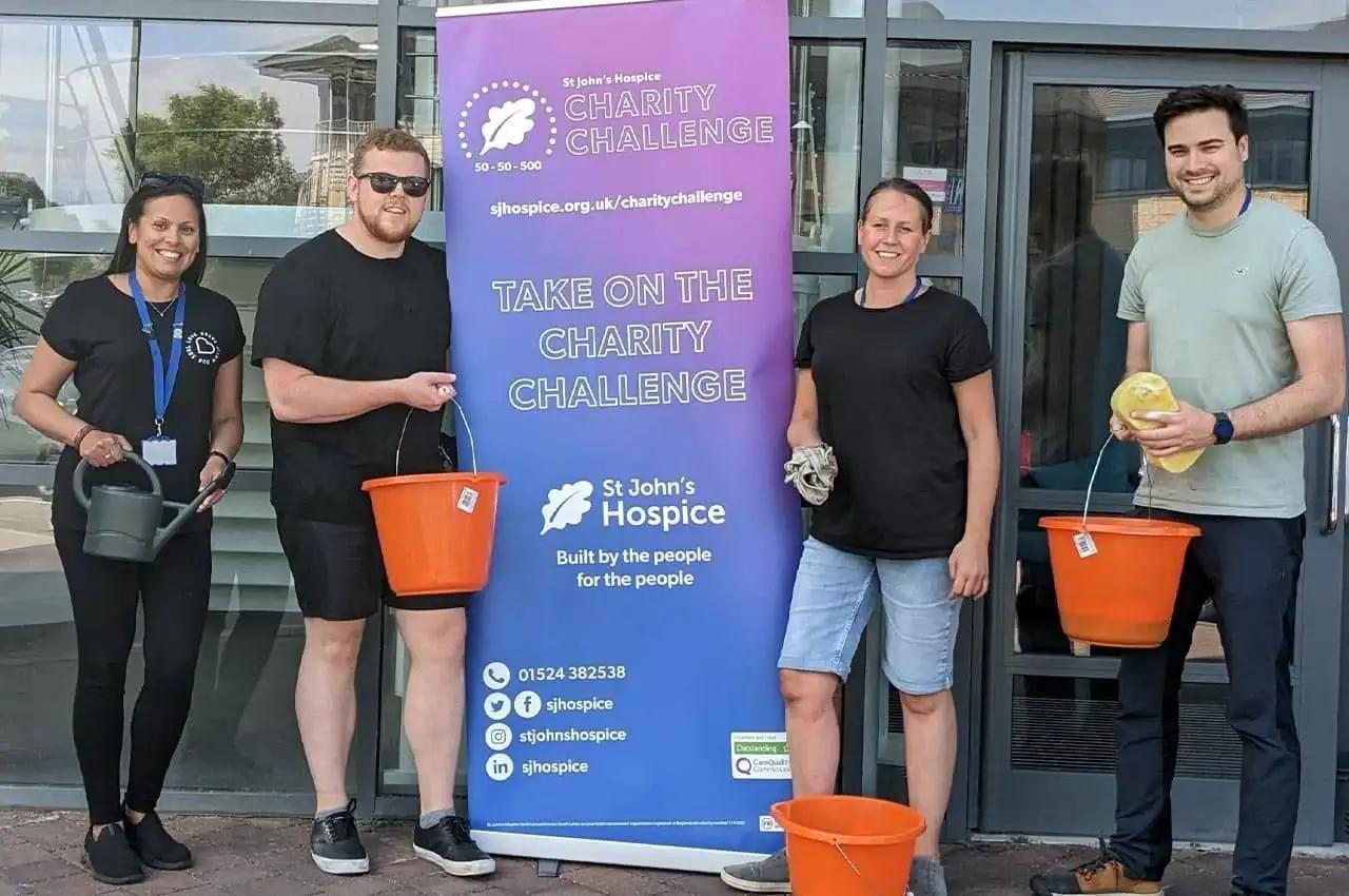The Premierline team stood with buckets and sponges