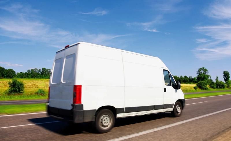 White van driving on the open road